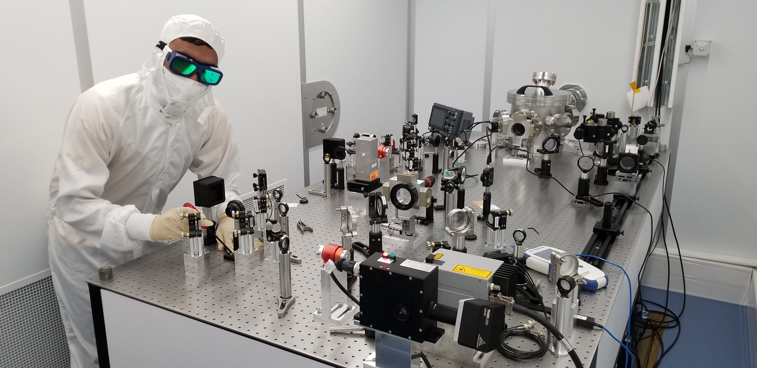 researcher with an optical table used for axion detection