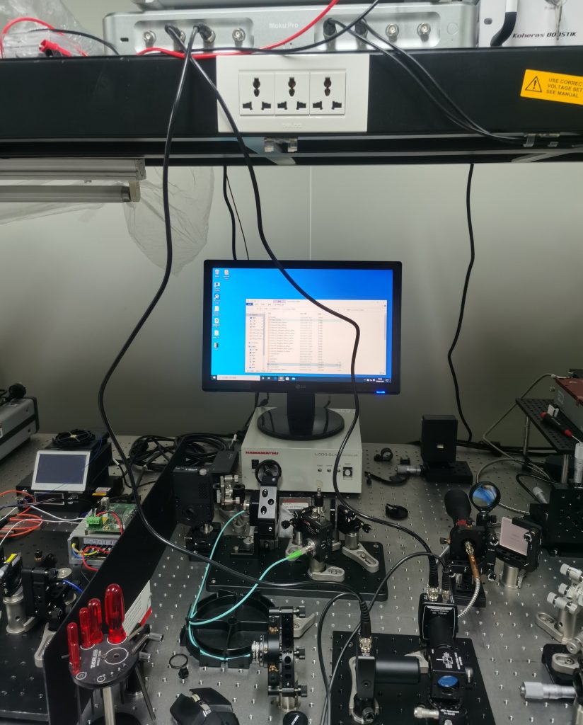 Moku:Pro (located on top rack) integrated into the QPE measurement setup in an optics laboratory